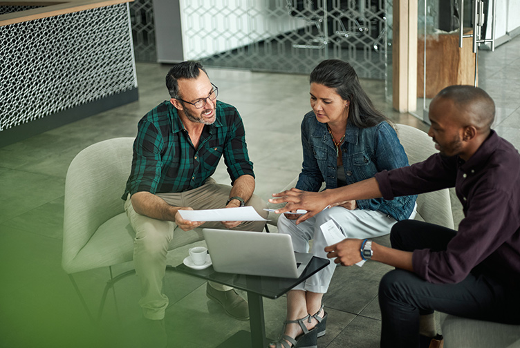 Agent sits with couple to discuss insurance coverage options.
